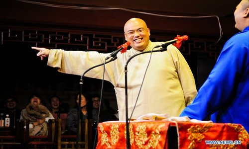 Cross talk actors perform on stage at a teahouse in Tianjin, north China, January 2, 2013.