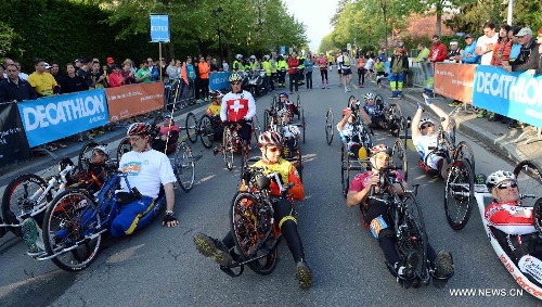 Competitors participate in the Half Marathon Handbike and armchair race during the 9th Geneva Marathon in Geneva, Switzerland, May 5, 2013. Swiss wheelchair athlete Heinz Frei claimed the title with 35:53:03. (Xinhua/Wang Siwei) 