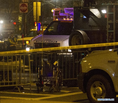 An ambulance and armored car sit at the scene of the explosion which killed three people in Boston, the United States, April 15, 2013. The two explosions that rocked the Boston Marathon on Monday has killed three people and injured at least 138, officials and media outlets said. (Xinhua/Marcus DiPaola)