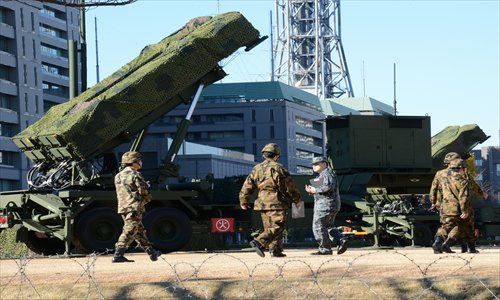 Officers of the Japanese Ground Self-Defense Force (SDF) walk in front of Japan's SDF set Patriot Advanced Capability-3 missile launcher at the Japanese Defense Ministry in Tokyo on Thursday. Photo: AFP