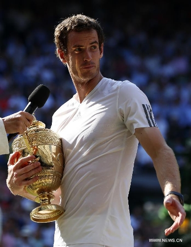 Andy Murray of Britain receives interview during the awarding ceremony for the men's singles event on day 13 of the Wimbledon Lawn Tennis Championships at the All England Lawn Tennis and Croquet Club in London, Britain, July 7, 2013. Andy Murray on Sunday won his first Wimbledon title and ended Britain's 77-year waiting for a men's champion with a 6-4 7-5 6-4 victory over world number one Novak Djokovic. (Xinhua/Wang Lili)