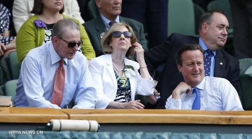 Jacques Rogge (L), president of the International Olympic Committee, talks with British Prime Minister David Cameron (R) during the men's singles final with Novak Djokovic of Serbia on day 13 of the Wimbledon Lawn Tennis Championships at the All England Lawn Tennis and Croquet Club in London, Britain, July 7, 2013. Andy Murray on Sunday won his first Wimbledon title and ended Britain's 77-year wait for a men's champion with a 6-4 7-5 6-4 victory over world number one Novak Djokovic. (Xinhua/Wang Lili) 