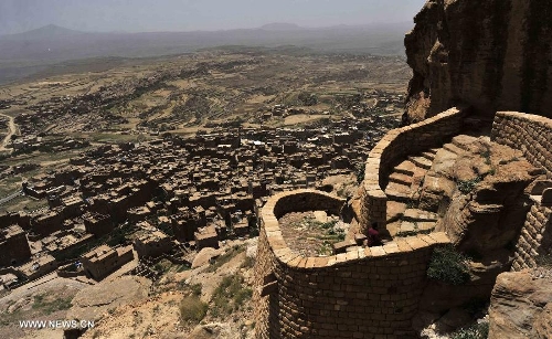 A Yemeni visitor walks on a path that leads to the Thula Fort at the historical city of Thula, 45 km north of Sanaa, Yemen, on May 12, 2013. Thula Fort is one of 20 nominees for the 2013 Aga Khan Award for Architecture which is given every three years to projects that set new standards of excellence in architecture, planning practices, historic preservation and landscape architecture, in which Muslims have a significant presence. Thula boasts an impressive collection of stone buildings that date back to the 1st millennium BCE. The Thula fort was threatened by the disruption that might ensue from the construction of a road. However, the Yemeni government has undertaken a series of historic preservation projects to protect cultural assets, including rebuilding the walls of burial grounds, watch towers, paths and waterways, and repairing the cistern that remains in use to this day.(Xinhua/Mohammed Mohammed) 