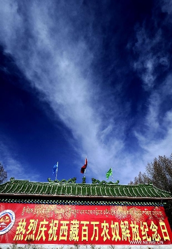 Photo taken on March 28, 2013 shows a wall poster marking the 54th anniversary of the abolishment of Tibet's feudal serfdom in Lhasa, capital of southwest China's Tibet Autonomous Region. Authorities have designated March 28 as the day to commemorate the 1959 democratic reform in Tibet, which ended the feudal serf system. The reform freed about 1 million Tibetans, over 90 percent of the region's population at the time, from a life of serfdom. (Xinhua/Chogo) 