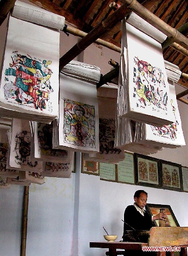  A folk artist makes traditional woodblock New Year pictures in Zhuxian Township of Kaifeng County, central China's Henan Province, Jan. 9, 2008. New Year Picture is usually made on various subjects, such as door god, conventions, carnivals, the Kitchen God, women and babies. As each Chinese New Year arrives, every family modifies its New Year picture in order to 