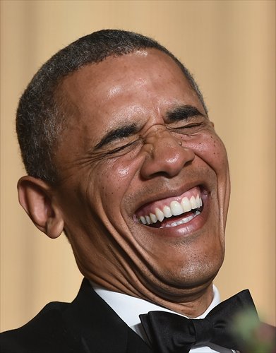 US President Barack Obama laughs as he listens to performer Joel McHale tell jokes during the White House Correspondents' Association Dinner on Saturday in Washington DC. Photo: AFP