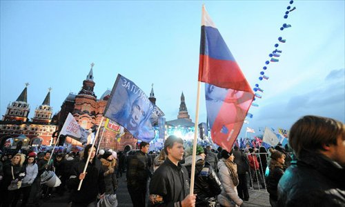 Supporters of Russian Prime Minister and presidential candidate Vladimir Putin rally at the central Manezhnaya Square just outside the Kremlin as they celebrate his victory in Moscow, Russia, Monday, March 5, 2012. Photo: Xinhua 