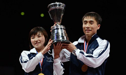 Kim Hyok Bong and Kim Jong of the Democratic People's Republic of Korea(DPRK) celebrate with the trophy during the awarding ceremony for mixed doubles at the 2013 World Table Tennis Championships in Paris, France on May 18, 2013. Kim Hyok Bong and Kim Jong defeated Lee Sang Su and Park Young Sook of South Korea by 4-2 to claim the title. (Xinhua/Tao Xiyi)