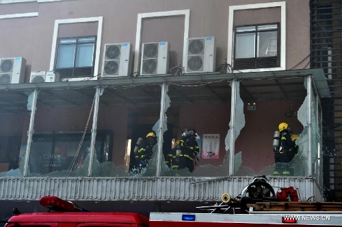 Fire fighters try to put out a fire broke out in a four-story commercial building in Liuzhou, south China's Guangxi Zhuang Autonomous Region, July 1, 2013. Twelve fire trucks and 49 firefighters have been dispatched to fight the blaze. No casualties have been reported thus far. (Xinhua) 