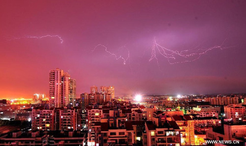 Photo taken on August 17, 2012 shows lightning above buildings as Typhoon Kai-Tak approaches in Nanning City, capital of south China's Guangxi Zhuang Autonomous Region. Kai-Tak is forecast to make landfall in coastal regions of south China's Guangdong Province at noon or during the morning of Friday, bringing heavy rain and gales to the country's southern parts, according to China Meteorological Administration (CMA). Photo: Xinhua