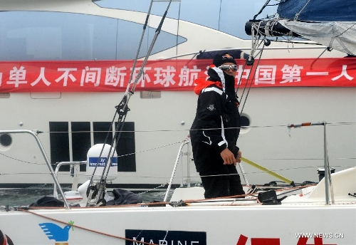 China's Guo Chuan sails toward the shore in Qingdao, east China's Shandong Province, April 5, 2013. Guo sailed back home on Friday morning to become the first Chinese to successfully circumnavigate the globe singlehanded. Aboard his Class40 yacht, 48-year-old Guo travelled about 21,600 nautical miles in 138 days before he returned to his hometown of Qingdao, where he set off on November 18 last year. (Xinhua/Li Ziheng)