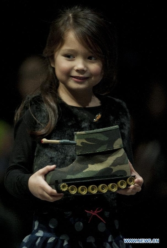 A young model presents an entry of the 13th Hong Kong Footwear Design Competition during the awarding ceremony of the event in south China's Hong Kong, Jan. 15, 2013. The ceremony is held on the second day of the Hong Kong Fashion Week for Fall/Winter, which lasts from Jan. 14 to Jan. 17 at Hong Kong Convention and Exhibition Centre. (Xinhua/Lui Siu Wai) 