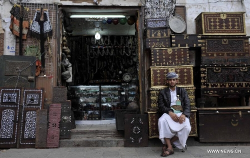 A vendor waits for customers on a street in the Old City of Sanaa, Yemen, on March 24, 2013. According to local media, Yemen's tourism sector suffered losses estimated at one billion U.S. dollars following the 2011 crisis. Vendors in the Old City of Sanaa, a UNESCO World Heritage Site, said the number of foreign tourists declined by at least 90 percent due to the 2011 unrest that severely undermines security in Yemen. (Xinhua/Mohammed Mohammed) 