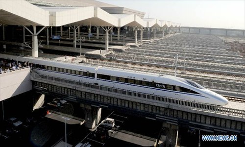 A high-speed train leaves the Zhengzhou East Railway Station in Zhengzhou, capital of central China's Henan Province, September 28, 2012. The Beijing-Zhengzhou high-speed railway will start service on December 26, connecting the functioning Zhengzhou-Wuhan and Wuhan-Guangzhou high-speed railway to become the world's longest high-speed railway. The new station is the biggest high-speed railway marshalling station of central China as well as a comprehensive passenger tranportation hub incorporating high-speed railway, road transportation, intercity railway, subway and bus. Photo: Xinhua