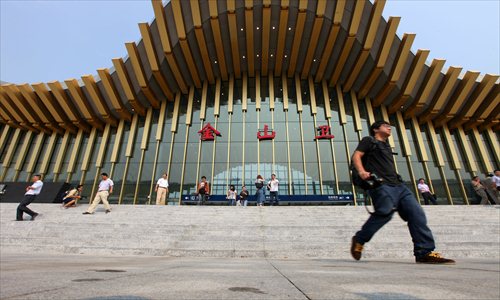 A photographer walks outside of Jinshanwei Station, the final destination of the new commuter rail line to Jinshan district. Photo: Cai Xianmin/GT