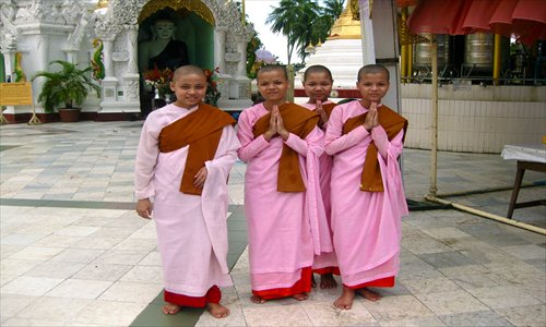 Young Buddhist girls pose for the camera. Photo: Bridget Riley/GT