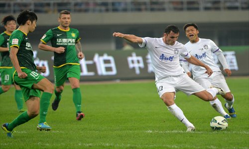 Tianjin Teda's Baré shoots during a Chinese Super League match against Beijing Guo'an at Tianjin Olympic Center Stadium in Tianjin on Saturday. Teda won the game 1:0 thanks to a goal from Carmelo Valencia. Tianjin have defeated last season's top three, Guangzhou Evergrande, Jiangsu Sainty and Guo'an, one by one in the ongoing season. Photo: CFP