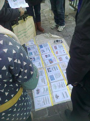 Petitioners surround a vendor peddling booklets near the national office of letters and calls in Beijing Sunday. Many of the pamphlets contain the contact information of high-ranking officials in State agencies and their addresses. Photo: GT/Zhang Zihan