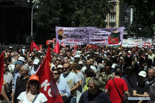 Protesters shout slogans and hold banners in front of the House of Parliament, in Athens, Greece, May 1, 2013. Greece is in the grip of a new 24-hour general strike on Wednesday, as the country's largest unions of public and private sector workers ADEDY and GSEE mark Labor Day with anti-austerity rallies in central Athens and other major cities. (Xinhua/Marios Lolos)  