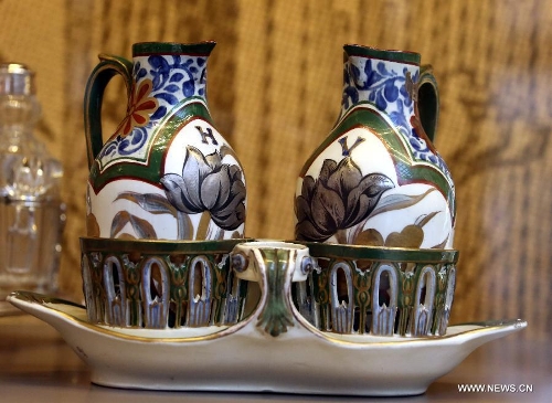 Photo taken on May 4, 2013 shows coloured pottery kettles made in the 19th century displayed in an exhibition of 