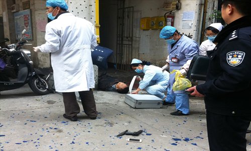 Police and medical crew examine the crime scene in Liuzhou, Guangxi Zhuang Autonomous Region where a local official was killed in a robbery attempt. Photo: CFP