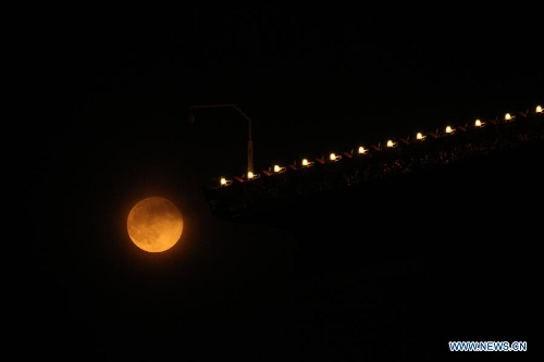 A full moon is seen in Beijing, capital of China, June 23, 2013. The moon looks 14 percent larger and 30 percent brighter than usual on Sunday. The scientific term for the phenomenon is 