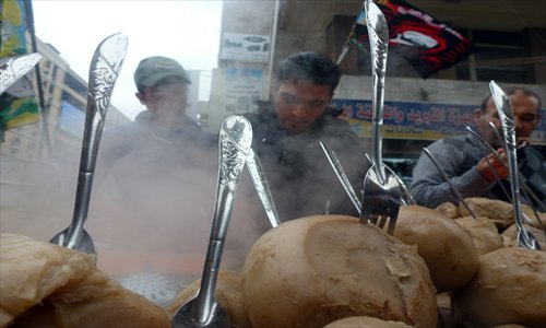 An Iraqi vendor sells Shalgham, Syrian turnip, on a street in Baghdad on Sunday. The price of the turnip has doubled over the past year due to the ongoing conflict in Syria, reaching a new high of 1,000 Iraqi dinars ($0.85), a vendor said. Photo: AFP