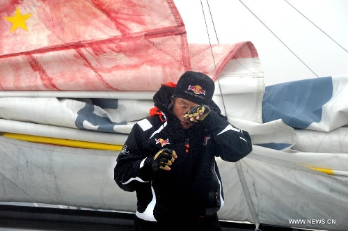 China's Guo Chuan wipes away tears after returning home in Qingdao, east China's Shandong Province, April 5, 2013. Guo sailed back home on Friday morning to become the first Chinese to successfully circumnavigate the globe singlehanded. Aboard his Class40 yacht, 48-year-old Guo travelled about 21,600 nautical miles in 138 days before he returned to his hometown of Qingdao, where he set off on November 18 last year. (Xinhua/Li Ziheng)