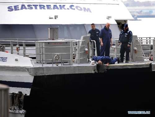  Members of United States Coast Guard inspect a ferry boat which crashed into Pier 11 in lower Manhattan, New York, the United States, on Jan. 9, 2013. A high-speed ferry loaded with hundreds of commuters from New Jersey crashed into a dock near Wall Street on Wednesday during the morning rush hour, injuring 57 people. (Xinhua/Shen Hong) 