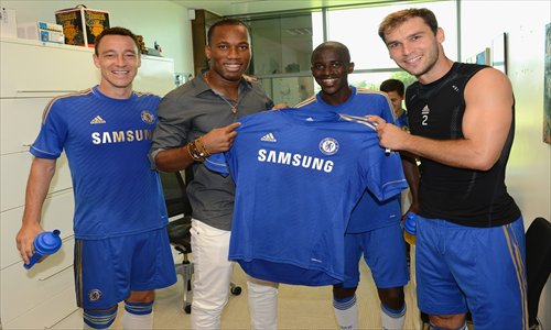 Former Chelsea midfielder Didier Drogba, left, holds his Shanghai