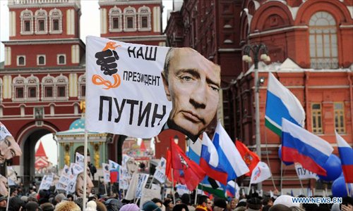 Supporters of Russian Prime Minister and presidential candidate Vladimir Putin rally at the central Manezhnaya Square just outside the Kremlin as they celebrate his victory in Moscow, Russia, Monday, March 5, 2012. Photo: Xinhua