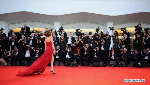 Photographers take photos by the red carpet of the Venice Film Festival in Venice, Italy, August 29, 2012. The 69th Venice International Film Festival opened here late Wednesday. Photo: Xinhua