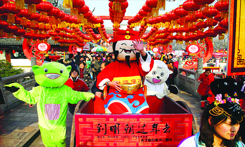 Performers dressed as cartoon characters accompany the God of Wealth in a parade at Confucius Temple in Nanjing, Jiangsu Province. Photo: CFP