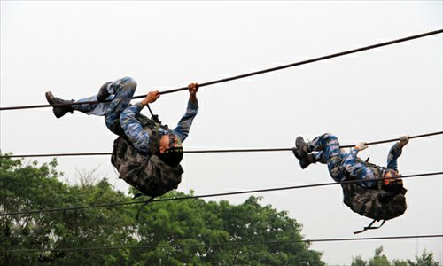 An armored regiment of the Marine Corps under the Navy of the Chinese People's Liberation Army (PLA) keeps the actual-combat requirements in mind and tempers its troops all-roundly. By adding the obstacles and setting up lifelike battle atmosphere in training, the regiment has cultivated the first-rate capability of the officers and men. (China Military Online/Zeng Liang)