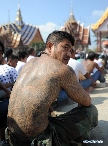 A devotee shows his tattooed body during the 