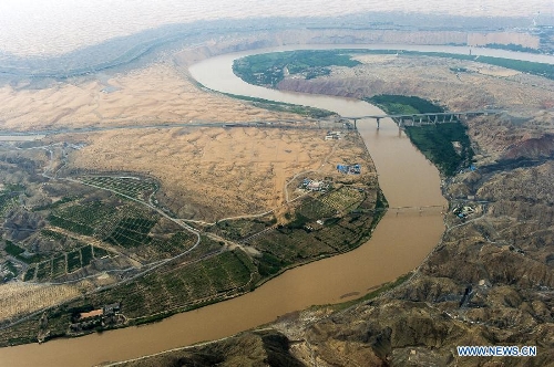The Yellow River flows in Zhongwei, a city in northwest China's Ningxia Hui Autonomous Region, June 29, 2013. The Yellow River, China's second longest which stretches for nearly 100 kilometers in Zhongwei, runs mainly in the Heishan Gorge. (Xinhua/Wang Peng) 