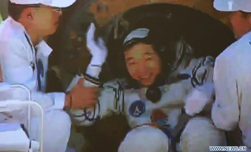 This screen shot taken on June 29, 2012 in the Beijing Aerospace Control Center shows Chinese astronaut Jing Haipeng coming out of the re-entry capsule of Shenzhou-9 spacecraft in Siziwang Banner of north China's Inner Mongolia Autonomous Region. Photo: Xinhua