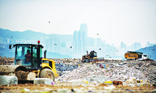 Heavy-duty vehicles transport garbage at Hong Kong's South East New Territories Landfill. Hong Kong will spend at least HK$31 billion ($3.99 billion) building infrastructure to handle waste through 2021 as it seeks to alleviate space shortages at local landfills. Hong Kong's landfills are predicted to reach their full capacity within the next seven years. Photo: CFP 