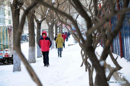 Pedestrian in thick clothing walk on a snow-covered sidewalk in Harbin, capital of northeast China's Heilongjiang Province, March 10, 2013. Temperature in Harbin significantly dropped to minus 19 degrees Celsius due to cold air on March 10. (Xinhua/Wang Song) 