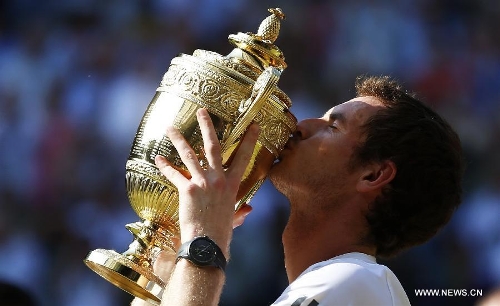 Andy Murray of Britain kisses the trophy during the awarding ceremony for the men's singles event on day 13 of the Wimbledon Lawn Tennis Championships at the All England Lawn Tennis and Croquet Club in London, Britain, July 7, 2013. Andy Murray on Sunday won his first Wimbledon title and ended Britain's 77-year waiting for a men's champion with a 6-4 7-5 6-4 victory over world number one Novak Djokovic. (Xinhua/Wang Lili)