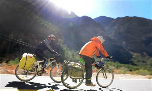 Tourists ride on the Sichuan-Tibet Highway in Bome County of Nyingchi Prefecture, southwest China's Tibet Autonomous Region, January 1, 2013.