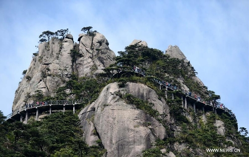 Tourists visit the Sanqing Mountain in east China's Jiangxi Province, April 13, 2013. The scenic area of Sanqing Mountain entered a peak tourist season as temperature rises recently. (Xinhua/Zhou Ke)  