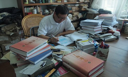 Wang Xiaojian, who has devoted his entire life to writing and compiling city records, at work in his office. Photo: Courtesy of the Office of Shanghai Chronicles