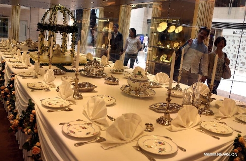 Visitors view tableware during an exhibition of 