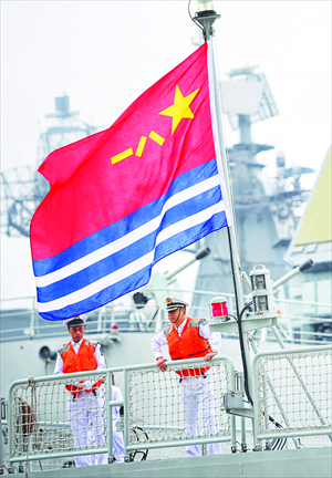 Two crewmen stand on the deck of one of seven Chinese warships which arrived in Russia's Far Eastern port of Vladivostok on Friday. China and Russia Friday started eight-day joint naval drills off the coast of Russia's Far East. It will be the largest maneuver China has ever held with a foreign navy (see story on page 2).   Photo: CFP