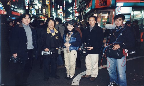 Zhang Liling (center) poses with the production team of Living in Tears for a group shot in Tokyo. 