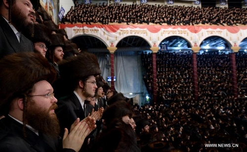 Jews of the Belz Hasidic Dynasty watch the wedding ceremony of Rabbi Shalom Rokeach, the grandson of the Belz Rabbi Yissachar Dov Rokeach, at the neighbourhood of Kiryat Belz in Jerusalem on May 21, 2013. More than 10,000 Jews participated in the wedding. (Xinhua/Yin Dongxun) 