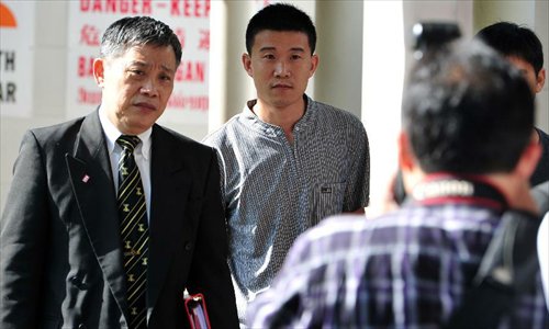 Chinese bus driver He Junling (C) attends court proceedings held at Subordinate Court in Singapore,  December 12, 2012. Four Chinese bus drivers charged with instigating illegal strike attended a court hearing in Singapore Wednesday. A total of 171 Chinese bus drivers took medical leave on November 26 in protest against inequitable pay rises by local public transport operator SMRT, and 88 of them stayed away from work the following day. Five drivers were arrested and charged, while 29 others had their work permits revoked and deported to China. Out of the arrested, Bao Fengshan was sentenced to six weeks in jail, and the remaining four charged with instigating an illegal strike were released on bail. Photo: Xinhua