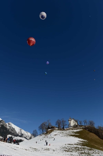 Balloons take off at the 35th International Ballon Festival in Chateau-d'Oex, Switzerland, Jan. 26, 2013. The 9-day ballon festival kicked off here on Saturday with the participation of over 80 balloons from 15 countries and regions. (Xinhua/Wang Siwei) 