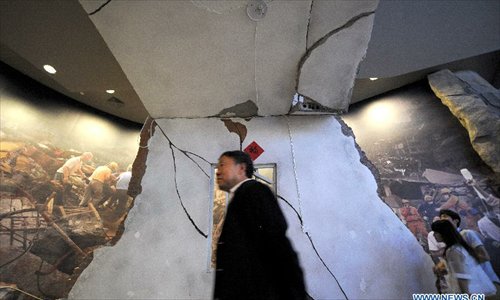 People visit the Wenchuan Earthquake Memorial Museum in the town of Qushan, Beichuan Qiang Autonomous County, southwest China's Sichuan Province, May 9, 2013. The museum was officially opened to the public for free on Thursday to commemorate the fifth anniversary of the Wenchuan earthquake, which hit Sichuan on May 12, 2008 and left more than 87,000 people dead or missing. (Xinhua/Xue Yubin) 